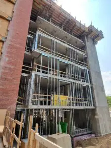 Building construction with brick and metal framing