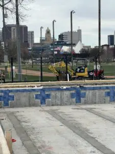 Excavator on baseball field, pool tiling