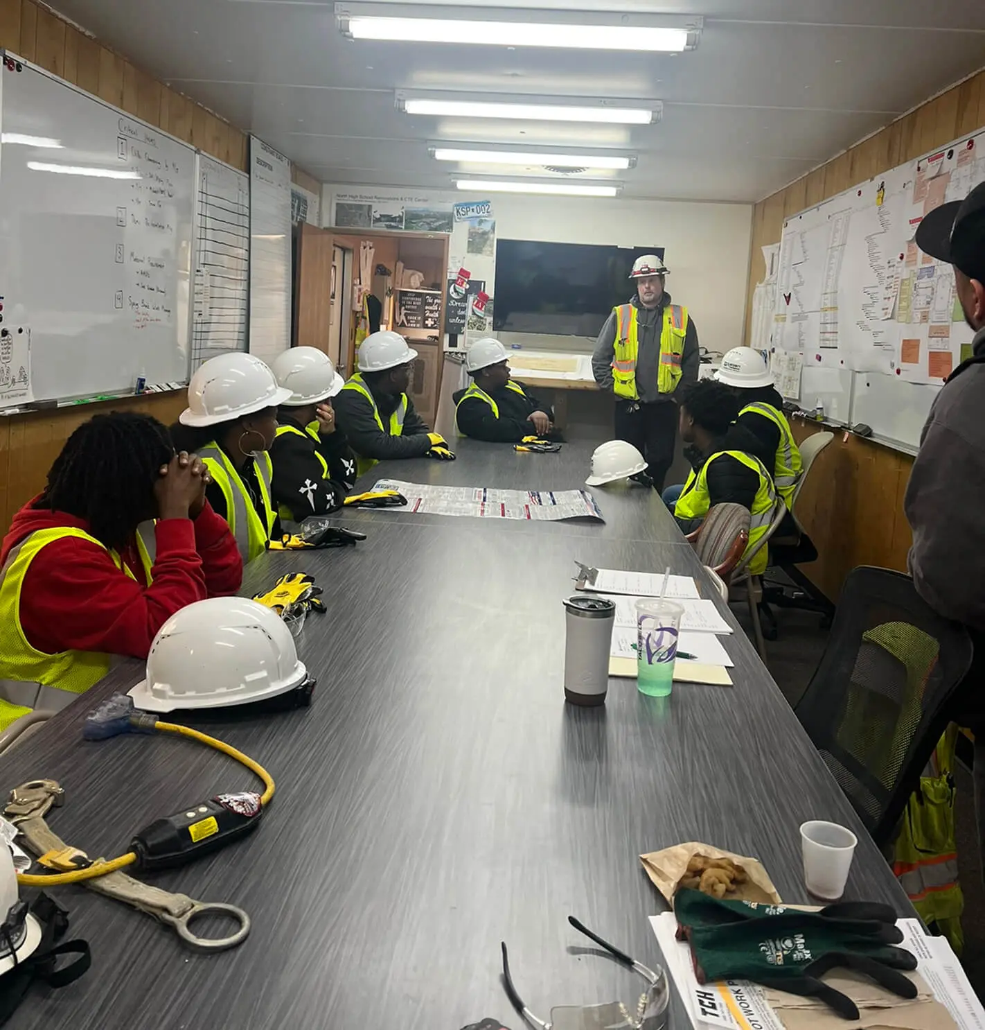 Workers in hard hats and safety vests