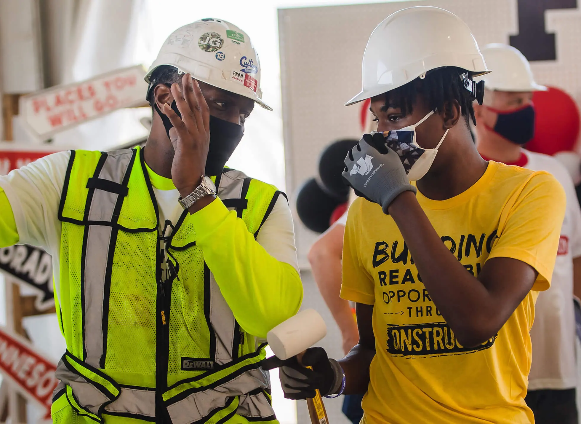 Apprentices with tools, wearing safety gear