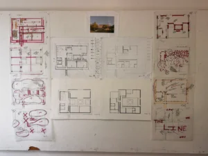 Architectural blueprints and sketches on a wall