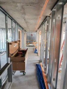 Unfinished building interior with tools and pipes