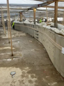 Concrete wall construction site with workers